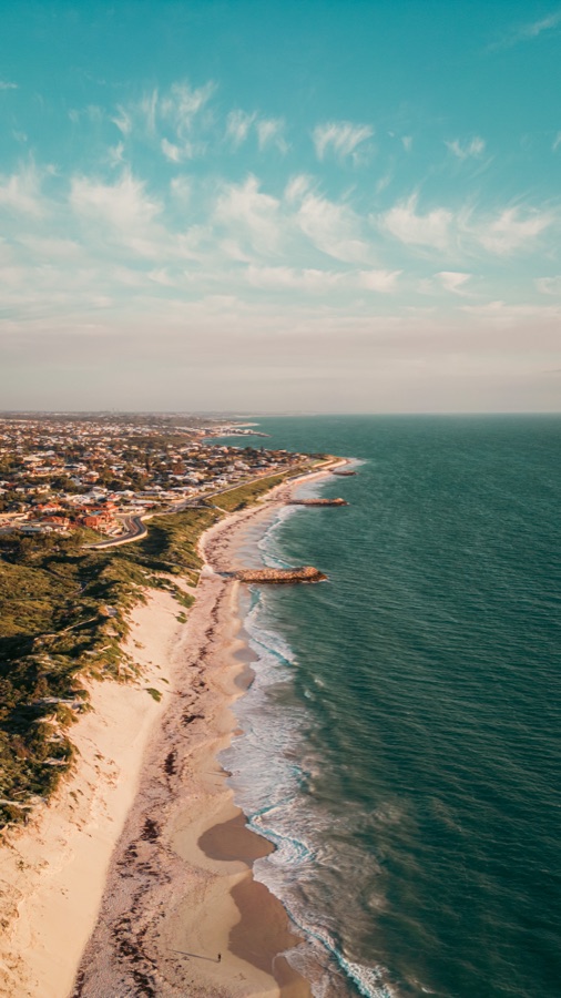 Aerial view along the pale shore and blue water at Quinns Rocks